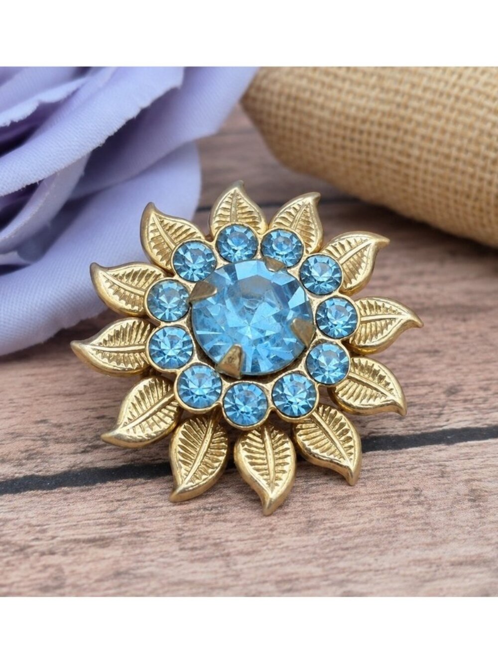 Vintage Blue Rhinestone Flower Brooch Gold Tone Leaf Floral Pin Unsigned 1.25”